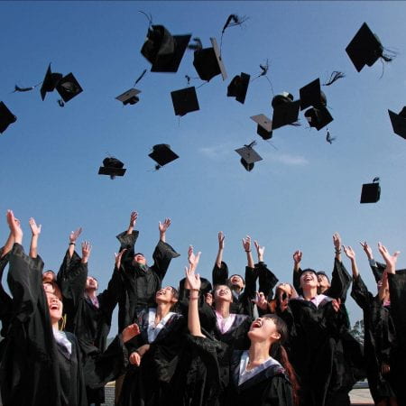 Students throwing their graduation cap
